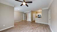 This single-floor residence in Overland Park, Kansas offers a well-designed open-concept layout that seamlessly connects the living, dining, and kitchen areas. Light wood-look flooring flows throughout the main living spaces, complemented by neutral warm-toned walls and crisp white trim, creating a clean and inviting atmosphere. Ceiling fans are featured in the living areas, contributing to both comfort and style.

The kitchen is thoughtfully appointed with white shaker-style cabinetry, light quartz countertops, a stainless steel sink, and a full suite of stainless steel appliances including a refrigerator with ice maker, electric range, microwave, and dishwasher. A peninsula provides additional counter space and serves as a natural transition to the open living area.

The living room is bathed in natural light, courtesy of a sliding glass door with vertical blinds that opens to the outdoors, alongside an additional window that further brightens the space. The bedroom features plush carpeting, a ceiling fan, and a window with blinds, while the primary suite includes direct access to a well-appointed bathroom with a white vanity, quartz countertop, undermount sink, and large mirror. A walk-in closet is also accessible from the bedroom. The overall ambiance is modern, clean, and move-in ready.
