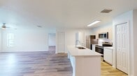 This contemporary apartment at MacAlpine Place offers a well-designed living space of 1090 square feet. The single-story layout encompasses two bedrooms and two bathrooms, with the primary bedroom boasting a generous 200 square feet. The open-concept design seamlessly integrates the kitchen and living areas, creating a spacious and airy atmosphere.

Throughout the apartment, gleaming hardwood floors add warmth and sophistication. The kitchen showcases modern amenities, including sleek white cabinetry and stainless steel appliances, perfect for culinary enthusiasts. Both bathrooms feature clean lines and updated fixtures, with at least one offering a glass-enclosed shower.

Large windows in the bedrooms and living areas allow ample natural light to flood the space, enhancing the bright and welcoming ambiance. Ceiling fans in the bedrooms provide additional comfort and air circulation. The apartment also includes convenient in-unit laundry facilities and ample closet space, with wire shelving systems for optimal organization.

The neutral color palette of white walls and light wood tones creates a versatile canvas for various decor styles. This thoughtfully designed apartment combines functionality and style, offering a comfortable and modern living environment in a prime location.