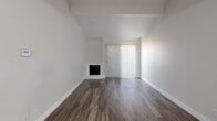 Located at 900 Frances Way in Richardson, TX, this single-floor, one-bedroom, two-bathroom residence offers a well-designed layout that makes efficient use of its space. The open living area immediately impresses with vaulted ceilings and a corner fireplace set against crisp white walls, creating a bright and airy atmosphere. Dark wood-style flooring runs throughout, lending a warm, cohesive aesthetic. A sliding glass door fitted with vertical blinds allows natural light to filter in while providing access to the outdoors.

The galley-style kitchen is a standout feature, showcasing rich dark cabinetry, granite countertops, a classic subway tile backsplash, and black appliances — all combining for a sleek, modern look. A dedicated pantry adds valuable storage. The kitchen flows conveniently into the combined dining and living area, supporting an open-concept feel.

The generously sized bedroom features a ceiling fan, a window with vertical blinds, and its own access to closet space. Four closets throughout the unit ensure abundant storage. The bathrooms are clean and functional, with one featuring a tiled tub-shower surround in a vertical stacked pattern. A hallway and entrance area round out the thoughtfully organized floor plan.