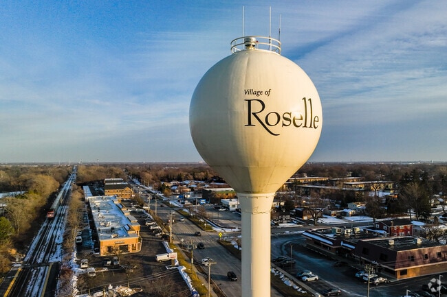 Overview of Roselle water tower with Metra train approaching.