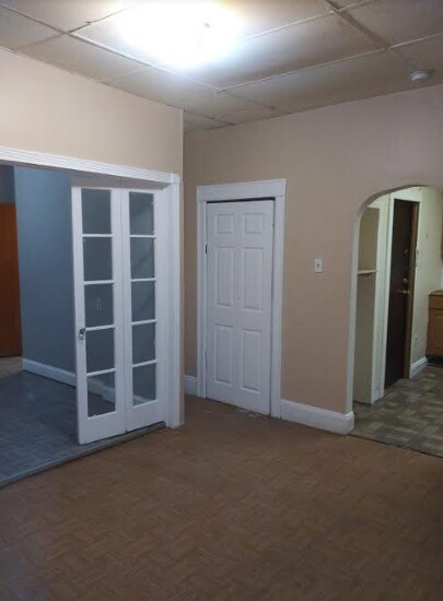 Living area with bedroom doors (left) and kitchen (right) - 1158 Summit Ave
