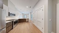 This well-designed apartment, located at 9 Central St in Somerville, MA, offers 710 square feet of living space on a single floor. The layout includes two bedrooms, a living room, and a kitchen, efficiently arranged to maximize the available area. The primary bedroom is particularly spacious at 230 square feet, providing ample room for rest and relaxation.

Throughout the apartment, beautiful hardwood floors create a warm and inviting atmosphere. The kitchen is a standout feature, boasting modern stainless steel appliances, including a French door refrigerator, built-in microwave, and a sleek gas range. The cabinetry combines white upper cabinets with wood-toned lower cabinets, creating a contemporary two-tone effect. A white tile backsplash and pendant lighting add to the kitchen's stylish appeal.

The bedrooms are well-proportioned, with one featuring a window that allows natural light to flood the space. Built-in closets provide valuable storage solutions. The living areas are bright and airy, with neutral-toned walls that offer a blank canvas for personalization. One room even includes sliding glass doors leading to an outdoor area, extending the living space and providing a connection to the outdoors.

Overall, this apartment combines modern amenities with efficient design, creating a comfortable and functional living space in a desirable Somerville location.