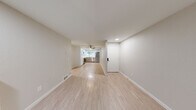 This well-appointed 4-bedroom, 1-bathroom home in Renton, WA offers a thoughtfully designed single-floor layout that maximizes functionality and comfort. The open-concept living and dining area serves as the heart of the home, highlighted by a classic white brick fireplace and light luxury vinyl plank flooring that extends throughout the main living spaces. Sliding glass doors lead directly to a private patio, allowing natural light to fill the room and providing a seamless indoor-outdoor connection. The modern kitchen is outfitted with stainless steel appliances, including a range, microwave, dishwasher, and refrigerator, complemented by two-tone cabinetry — white uppers paired with warm wood-toned lowers — a subway tile backsplash, stone-look countertops, and a ceiling fan overhead. The four bedrooms are carpeted for comfort, each featuring windows that invite natural light and views of the surrounding greenery. Multiple closets throughout provide generous storage. The bathroom is clean and functional, featuring a tub/shower combo, wood-toned vanity, and light flooring consistent with the home's overall aesthetic. A dedicated laundry area and a hallway connecting all spaces complete this practical and inviting layout.