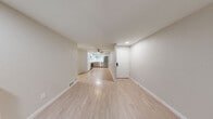 This well-appointed 4-bedroom, 1-bathroom home in Renton, WA offers a thoughtfully designed single-floor layout that maximizes functionality and comfort. The open-concept living and dining area serves as the heart of the home, highlighted by a classic white brick fireplace and light luxury vinyl plank flooring that extends throughout the main living spaces. Sliding glass doors lead directly to a private patio, allowing natural light to fill the room and providing a seamless indoor-outdoor connection. The modern kitchen is outfitted with stainless steel appliances, including a range, microwave, dishwasher, and refrigerator, complemented by two-tone cabinetry — white uppers paired with warm wood-toned lowers — a subway tile backsplash, stone-look countertops, and a ceiling fan overhead. The four bedrooms are carpeted for comfort, each featuring windows that invite natural light and views of the surrounding greenery. Multiple closets throughout provide generous storage. The bathroom is clean and functional, featuring a tub/shower combo, wood-toned vanity, and light flooring consistent with the home's overall aesthetic. A dedicated laundry area and a hallway connecting all spaces complete this practical and inviting layout.