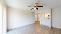 Located at 12000 Fleming Dr in Houston, TX, this single-story, 3-bedroom, 2-bathroom residence offers a well-organized layout designed for comfortable everyday living. Light wood-style flooring flows consistently throughout the home, creating a clean and cohesive aesthetic.

The open living room is bright and airy, featuring a ceiling fan with light fixture and a sliding glass door that leads to a private patio overlooking a landscaped courtyard with a playground area. The adjacent dining room connects naturally to the galley-style kitchen, which is outfitted with white shaker cabinetry, marble-look countertops, a stainless steel double-basin sink, and black appliances including an electric range and refrigerator.

The spacious primary bedroom includes a ceiling fan and dedicated closet access. Two additional bedrooms each offer ceiling fans, closet space, and natural light from window blinds. The unit includes three closets in total, providing ample storage throughout.

Both bathrooms are finished with clean white tilework and tub/shower combinations. One bathroom features a marble-look vanity countertop with an undermount sink. An in-unit laundry area and a hallway connecting the rooms complete this practical and well-appointed floor plan.