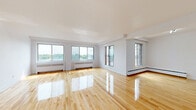 Located at 6920 Avenue Fielding in Montréal's Côte-Saint-Luc neighbourhood, this generously sized 3-bedroom, 2-bathroom unit offers a well-organized, single-floor layout with a comfortable sense of space throughout. Polished hardwood flooring flows seamlessly through the living room, hallways, and all three bedrooms, lending warmth and continuity to the interior. The bright, expansive living room is a standout feature, with large windows and a sliding door opening onto a balcony that offers views of the surrounding greenery and cityscape, filling the space with abundant natural light. The primary bedroom is notably spacious, accompanied by two additional well-proportioned bedrooms, each with their own windows. The kitchen is equipped with white cabinetry, a tile backsplash, warm-toned countertops, and a window, and opens directly into the living area for a connected feel. The two bathrooms offer distinct finishes — one features classic white tile with a shower, while the other is appointed with marble-style tile surrounding a full soaking tub. Radiator heating is present throughout. The layout also includes a dedicated entrance and two hallways, providing practical circulation and storage potential across this substantial urban residence.