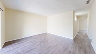 Located in Clearwater, Florida, this single-floor 2-bedroom, 2-bathroom residence offers a practical and well-organized layout designed for comfortable everyday living. The interior features durable wood-look plank flooring throughout the main living areas and hallway, complemented by neutral beige walls and white trim that create a clean, cohesive aesthetic. Textured ceilings are present throughout the home.

The living and dining areas provide an open, versatile space for relaxing and entertaining. The hallway connects the main living areas to the private quarters, with ample closet storage — five closets in total — distributed throughout the home to meet a variety of organizational needs.

Both bedrooms are carpeted for added comfort and feature windows that allow natural light to fill the rooms. The primary bedroom includes access to a dedicated walk-in closet. The second bedroom also benefits from a large window with vertical blinds.

The two bathrooms are finished with clean, white fixtures. One features a full tub-shower combo with tiled surround, while the other includes a vanity with dark countertop, wood-look flooring, and a tub. The kitchen is efficiently laid out to maximize functionality within the available space. Overall, the residence presents a tidy, move-in-ready environment in a convenient Clearwater location.