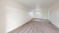 Located at 2075 N Highland Ave in Clearwater, Florida, this single-floor, one-bedroom, one-bathroom unit offers a functional and well-organized layout. The combined living and dining area serves as the heart of the home, featuring neutral carpet flooring, bright white walls, and a textured ceiling. A large sliding glass door floods the space with natural light and provides direct views of the outdoors, while a pendant light fixture illuminates the dining area near the front entrance. The kitchen is thoughtfully designed with white cabinetry, granite-style countertops, light wood-look flooring, and a full suite of appliances including an electric range with overhead ventilation. Ample counter and cabinet space makes it highly practical. The generously sized bedroom features plush carpet, a wide window with natural light, and a full-width louvered closet, with additional closets found throughout the unit for exceptional storage. The bathroom is clean and bright, outfitted with light wood-look tile flooring, a granite-top vanity, and a full-size tub and shower combination. A dedicated utility room and hallway round out the layout, contributing to an efficient, move-in-ready living space in the heart of Clearwater.