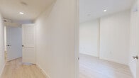 Located at 1343 Tamarind Ave in the heart of Hollywood, Los Angeles, this modern 4-bedroom, 4-bathroom unit offers a thoughtfully designed single-floor layout. Light wood-tone flooring flows consistently throughout, lending warmth and visual cohesion to every room.

The kitchen is a standout feature, outfitted with a full suite of stainless steel appliances including a gas range, over-the-range microwave, dishwasher, and French door refrigerator. Warm wood cabinetry extends to the ceiling for ample storage, complemented by a white quartz countertop and a subtle patterned tile backsplash.

Each of the four bedrooms is finished with crisp white walls, recessed lighting, and large windows that invite natural light. Several bedrooms include mirrored sliding closet doors, and the primary bedroom features direct access to its own private en-suite bathroom.

All four bathrooms share a consistent modern aesthetic, each featuring wood-toned vanities with white countertops, frameless glass-enclosed walk-in showers lined with large-format tile, and hexagonal mosaic tile flooring. Two hallways connect the rooms efficiently throughout the unit.

The overall ambiance is clean, contemporary, and move-in ready, reflecting a minimalist design sensibility well-suited to urban living in one of Los Angeles' most central neighborhoods.