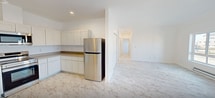 This contemporary 900 square foot apartment in Moses Lake, WA, offers a well-designed living space with two bedrooms and two bathrooms. The open-concept layout seamlessly blends the kitchen and living areas, creating a spacious feel enhanced by the abundance of natural light from large windows and sliding glass doors leading to a balcony.

The kitchen is equipped with modern white cabinetry, stainless steel appliances, and ample counter space, perfect for culinary enthusiasts. The living area is versatile, allowing for various furniture arrangements to suit different lifestyles.

The primary bedroom, measuring a generous 190 square feet, provides ample space for relaxation and storage. Both bedrooms feature large closets with sliding doors, ensuring plenty of storage options.

The bathrooms are designed with practicality in mind, featuring white fixtures, vanities with storage, and bathtub-shower combinations. The entire apartment boasts elegant marble-look flooring, adding a touch of luxury to the space.

Climate control is ensured through wall-mounted air conditioning units, providing year-round comfort. The apartment's neutral color palette and clean lines create a blank canvas for personal decorating styles, while the balcony offers an outdoor extension for fresh air and views of the surrounding area.

Located in a multi-story complex, this apartment combines modern amenities with a convenient location, making it an ideal choice for those seeking a contemporary living space in Moses Lake.
