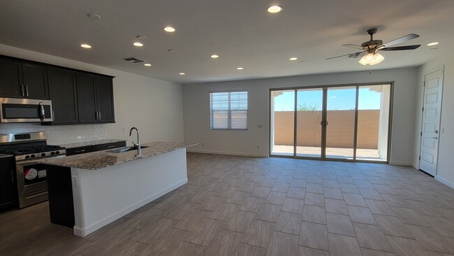Curtain shades have been installed on the 4 panel sliding door windows - 5927 S Coyote Canyon