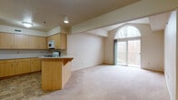 Located on the third floor, this 1-bedroom, 1-bathroom unit offers a thoughtfully designed open-concept layout that maximizes both space and functionality. The living area is anchored by striking vaulted ceilings that lend a sense of volume and airiness to the room. Soft, neutral carpeting flows throughout the main living space, creating a warm and inviting atmosphere. A large arched window and sliding glass door flood the interior with natural light while providing access to a private balcony with outdoor views, perfect for enjoying the surrounding scenery.

The kitchen is seamlessly integrated into the living space, separated by a peninsula breakfast bar that doubles as a casual dining area. Light maple cabinetry with ample storage lines the kitchen walls, complemented by clean white countertops, a gas range, and an over-the-range microwave. Tile flooring in the kitchen and bathroom areas provides a practical contrast to the carpeted living spaces.

The bathroom is clean and functional, featuring a tub-shower combination, a wood-toned vanity with counter space, tile flooring, and chrome fixtures. The bedroom offers a quiet retreat with generous proportions and closet space. Overall, this unit presents a comfortable and well-organized living environment with a bright, open feel throughout.