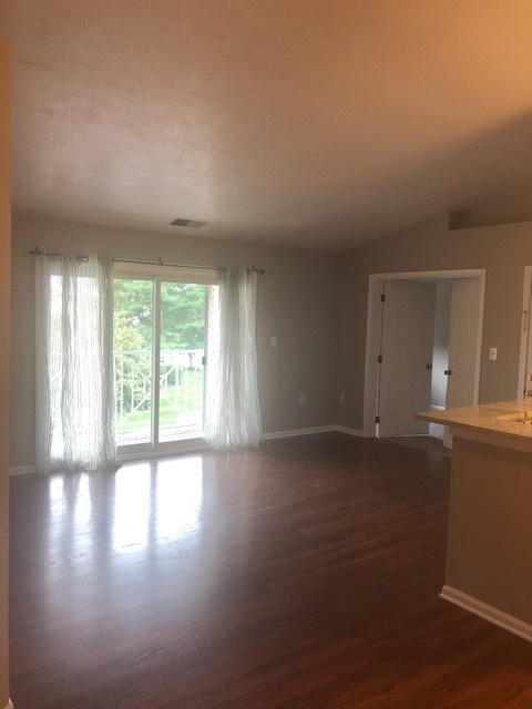 Living room with a balcony view - 1208 Mist Wood Ct