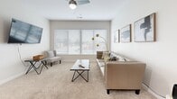 Located at 1005 W Fifth Ave in Columbus, OH, this thoughtfully designed 2-bedroom, 2-bathroom residence offers a comfortable and modern living experience across a single floor. The open-concept layout seamlessly connects the kitchen, dining, and living areas, creating a spacious and social atmosphere. The kitchen is a standout feature, boasting rich dark cabinetry, granite countertops, stainless steel appliances, and a large central island with pendant lighting and bar seating — ideal for both cooking and entertaining. Hardwood-style flooring runs through the kitchen and dining area, transitioning to plush carpet in the living room and bedrooms. The living room is bright and airy, with a wide bank of windows fitted with blinds that invite ample natural light and city views, complemented by a ceiling fan overhead. Both bedrooms are well-proportioned, carpeted, and feature windows with outdoor views, offering a calm retreat. The primary bedroom provides generous space. The two bathrooms are finished with large-format tile flooring, dark wood vanities, and granite countertops. Additional conveniences include multiple closets, a dedicated laundry area, and a hallway connecting the private quarters of the residence.