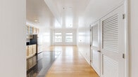 Located in the heart of Downtown Los Angeles, this 1-bedroom, 2-bathroom residence offers a thoughtfully designed single-floor layout. Warm hardwood flooring flows throughout the living spaces, complemented by crisp white walls that maximize the sense of brightness and openness.

The kitchen is a standout feature, appointed with natural maple cabinetry, dark granite countertops, polished dark tile flooring, and a full suite of stainless steel appliances including a double oven, dishwasher, microwave, and refrigerator. Abundant upper cabinetry with glass-front doors provides generous storage.

The open living area transitions seamlessly from the kitchen, bathed in natural light through large windows with views of the surrounding urban streetscape. The generously sized primary bedroom offers its own windows with city views, and connects to a dedicated closet with louvered doors. A second closet provides additional storage. Both bathrooms feature tile flooring, with one showcasing a dark granite vanity countertop atop warm wood cabinetry. The hallway connects all areas efficiently, contributing to the unit's smooth flow. Clean, modern finishes and an abundance of natural light define the overall ambiance of this Downtown LA residence.