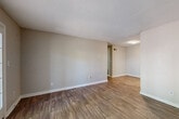 This single-floor, 2-bedroom, 1-bathroom unit offers a functional and comfortable layout across a thoughtfully designed floor plan. The open living area features warm hardwood-style flooring, neutral-toned walls, and a textured ceiling, creating a bright and welcoming atmosphere. A standout feature is the set of French doors that flood the space with natural light while providing access to the outdoors.

The kitchen is well-equipped with dark cabinetry, white quartz-style countertops, a subway tile backsplash, a stainless steel sink, and stainless steel appliances including a dishwasher and range, all set on light hardwood-style flooring.

Both bedrooms are carpeted and offer ample space, with neutral walls and textured ceilings. The primary bedroom is generously sized and includes a dedicated closet with built-in shelving, providing excellent storage. The second bedroom features a sliding-door closet. A hallway connects the bedrooms to the shared full bathroom, which includes a tiled tub-shower combination and hardwood-style flooring.

Additional storage is provided by a dedicated closet space with built-in shelving and carpet flooring. The overall design is clean, neutral, and move-in ready, offering a practical and comfortable living environment.