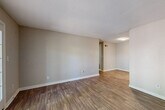This single-floor, 2-bedroom, 1-bathroom unit offers a functional and comfortable layout across a thoughtfully designed floor plan. The open living area features warm hardwood-style flooring, neutral-toned walls, and a textured ceiling, creating a bright and welcoming atmosphere. A standout feature is the set of French doors that flood the space with natural light while providing access to the outdoors.

The kitchen is well-equipped with dark cabinetry, white quartz-style countertops, a subway tile backsplash, a stainless steel sink, and stainless steel appliances including a dishwasher and range, all set on light hardwood-style flooring.

Both bedrooms are carpeted and offer ample space, with neutral walls and textured ceilings. The primary bedroom is generously sized and includes a dedicated closet with built-in shelving, providing excellent storage. The second bedroom features a sliding-door closet. A hallway connects the bedrooms to the shared full bathroom, which includes a tiled tub-shower combination and hardwood-style flooring.

Additional storage is provided by a dedicated closet space with built-in shelving and carpet flooring. The overall design is clean, neutral, and move-in ready, offering a practical and comfortable living environment.