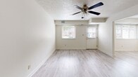 Located at 80 Sandune Drive in Pittsburgh, PA, this two-story home offers a practical and comfortable layout spread across two floors. The main level features a bright, open living room with light wood-look flooring, a ceiling fan, and windows that allow natural light to fill the space. A staircase connects the main level to the upper floor, adding to the home's functional flow. The kitchen is well-appointed with white cabinetry, granite-style countertops, a full suite of white appliances including a refrigerator, electric range, dishwasher, and microwave, all complemented by light wood-look flooring. A utility room rounds out the lower level. Upstairs, two carpeted bedrooms provide comfortable retreats, each featuring ceiling fans and windows with natural light. The primary bedroom is generously sized and includes closet space, while the second bedroom offers a quieter, cozy atmosphere. The full bathroom is outfitted with a tub-shower combination, a vanity, and tile flooring. Throughout the home, textured ceilings and neutral wall tones create a clean, consistent aesthetic. The exterior features brick construction with a small landscaped front area, adding curb appeal to this well-structured Pittsburgh residence.