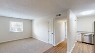 This 2-bedroom, 1-bathroom unit in Lexington, SC offers a practical and well-appointed single-floor layout designed for comfortable everyday living. The living room serves as the central gathering space, featuring wood-look flooring that transitions seamlessly from the entry area, while neutral-toned walls and a textured ceiling create a clean, understated aesthetic throughout.

The kitchen stands out as a notable highlight, equipped with stainless steel appliances including a range, over-the-range microwave, dishwasher, and refrigerator. Crisp white cabinetry provides ample storage, while granite-look countertops and a bold teal accent wall add a touch of modern style. Wood-look flooring carries through this space as well.

Both bedrooms are carpeted for warmth and comfort, each featuring neutral walls, textured ceilings, and windows that allow natural light to filter in. The primary bedroom offers a generous footprint, while the second bedroom provides versatile space suitable for a guest room or home office. A closet provides dedicated storage within the unit.

The full bathroom features a tub-shower combination, a white vanity with granite-look countertop, and wood-look flooring, maintaining the clean and consistent design found throughout the home. A hallway connects the rooms, completing this efficiently designed layout.