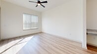 Located at 3108 McGinnis Ferry Rd in Suwanee, GA, this thoughtfully designed one-bedroom, one-bathroom residence offers a bright, modern living experience within a well-utilized floor plan. The open-concept living area seamlessly connects the kitchen, dining, and living spaces, all finished with light hardwood-style flooring that enhances the airy, cohesive feel of the space.

The kitchen is a standout feature, showcasing a central island with a granite countertop and a matte black pull-down faucet, illuminated by two globe pendant lights. Gray shaker-style cabinetry extends floor to ceiling, complemented by a white subway tile backsplash and a full suite of stainless steel appliances, including a refrigerator with ice and water dispenser, range, and over-the-range microwave. An additional granite-topped counter provides extra prep or serving space.

The bedroom offers plush carpeting, natural light through a large window with blinds, a ceiling fan, and a custom built-in closet with modern paneled doors. Two closets provide ample storage throughout the unit.

The bathroom features a dual-sink granite vanity with gray cabinetry and matte black hardware, a framed mirror, and a tiled tub-shower combination. A dedicated laundry area adds everyday convenience, completing this polished and functional home.