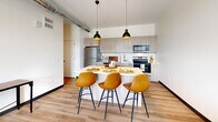 Located in Pittsburgh's vibrant Strip District, this one-bedroom, one-bathroom unit at 2930 Smallman Street offers a thoughtfully designed modern living space. The open-concept kitchen and living area serves as the heart of the unit, showcasing light wood cabinetry, stainless steel appliances, a classic subway tile backsplash, and a central island with pendant lighting — ideal for both cooking and casual dining. Exposed industrial ductwork adds a loft-inspired character throughout, complementing the warm hardwood-style flooring that flows through the main living areas. The bedroom features plush carpet, a generous window with urban rooftop views of the Pittsburgh skyline, and access to ample closet space. The full bathroom is finished with a wide-format vanity mirror, light wood cabinetry, and clean white countertops, maintaining the unit's crisp, contemporary aesthetic. A dedicated in-unit laundry area adds everyday convenience. The hallway connects all spaces efficiently while maintaining an open, airy feel. With modern finishes, industrial accents, and a well-considered layout, this unit delivers a comfortable and stylish urban living experience in one of Pittsburgh's most dynamic neighborhoods.