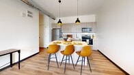 Located in Pittsburgh's vibrant Strip District, this one-bedroom, one-bathroom unit at 2930 Smallman Street offers a thoughtfully designed modern living space. The open-concept kitchen and living area serves as the heart of the unit, showcasing light wood cabinetry, stainless steel appliances, a classic subway tile backsplash, and a central island with pendant lighting — ideal for both cooking and casual dining. Exposed industrial ductwork adds a loft-inspired character throughout, complementing the warm hardwood-style flooring that flows through the main living areas. The bedroom features plush carpet, a generous window with urban rooftop views of the Pittsburgh skyline, and access to ample closet space. The full bathroom is finished with a wide-format vanity mirror, light wood cabinetry, and clean white countertops, maintaining the unit's crisp, contemporary aesthetic. A dedicated in-unit laundry area adds everyday convenience. The hallway connects all spaces efficiently while maintaining an open, airy feel. With modern finishes, industrial accents, and a well-considered layout, this unit delivers a comfortable and stylish urban living experience in one of Pittsburgh's most dynamic neighborhoods.