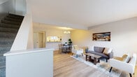 Located at 7820 Lexington Ave in Cleveland, Ohio, this two-story, 2-bedroom, 2-bathroom home offers a practical and comfortable layout spread across two well-proportioned floors. The main level welcomes you through a bright entryway with a classic paneled front door featuring sidelights, allowing natural light to fill the space. Light-toned hardwood-style flooring flows throughout the first floor, connecting the living room, dining area, and kitchen. The living room is a cozy, well-lit space with large windows dressed in horizontal blinds. Adjacent, the dining area is highlighted by a modern chandelier and opens via a pass-through counter to the galley-style kitchen, which features white cabinetry, warm yellow countertops, and full-size appliances. Upstairs, the two bedrooms offer plush carpeting, generous closet space with sliding or bi-fold doors, and multiple windows that invite natural light and outdoor views of surrounding greenery. The spacious primary bedroom is particularly well-lit. Both bathrooms are clean and functional, with the full bath featuring a tub-shower combo, a wide vanity with ample cabinetry, and hardwood-style flooring. A hallway connects all upper-level spaces efficiently, completing this well-organized home.