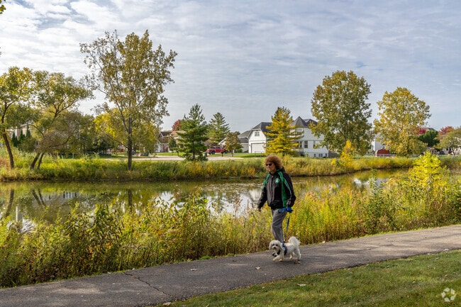 A resident of Western Slope walks along one of the many walking paths in a park.