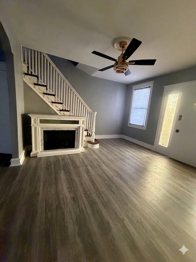 Living room with heater fire place and ceiling Tv mount able to hold up to 100” - 4744 Sheffield Ave Townhome