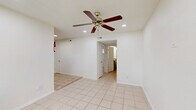 Located at 1742 Woodvine in Houston, TX 77055, this single-story 2-bedroom, 1-bathroom home offers a practical and efficient layout across its single floor. Light-toned ceramic tile flooring runs consistently throughout the entire space, lending a clean, cohesive look to every room.

The kitchen is a functional highlight of the home, featuring slate-blue shaker-style cabinetry, granite-look countertops arranged in an L-shape, a gas range, and a window above the sink that brings in natural light. The layout provides ample counter space and storage for everyday cooking needs.

Both bedrooms are bright and simply appointed, each equipped with a ceiling fan with light fixture. The primary bedroom offers a generous footprint and includes a built-in closet with shelving for storage. Windows in each bedroom allow natural light to filter in, enhancing the airy feel of the rooms.

The single bathroom features tile flooring, a tiled shower/tub combination, a granite-top vanity with an undermount sink, and a window that provides natural ventilation. A connecting hallway ties the rooms together, contributing to the home's straightforward and easy-to-navigate floor plan. Overall, the space presents a clean, no-frills living environment well-suited for practical everyday living.