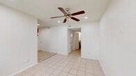 Located at 1742 Woodvine in Houston, TX 77055, this single-story 2-bedroom, 1-bathroom home offers a practical and efficient layout across its single floor. Light-toned ceramic tile flooring runs consistently throughout the entire space, lending a clean, cohesive look to every room.

The kitchen is a functional highlight of the home, featuring slate-blue shaker-style cabinetry, granite-look countertops arranged in an L-shape, a gas range, and a window above the sink that brings in natural light. The layout provides ample counter space and storage for everyday cooking needs.

Both bedrooms are bright and simply appointed, each equipped with a ceiling fan with light fixture. The primary bedroom offers a generous footprint and includes a built-in closet with shelving for storage. Windows in each bedroom allow natural light to filter in, enhancing the airy feel of the rooms.

The single bathroom features tile flooring, a tiled shower/tub combination, a granite-top vanity with an undermount sink, and a window that provides natural ventilation. A connecting hallway ties the rooms together, contributing to the home's straightforward and easy-to-navigate floor plan. Overall, the space presents a clean, no-frills living environment well-suited for practical everyday living.