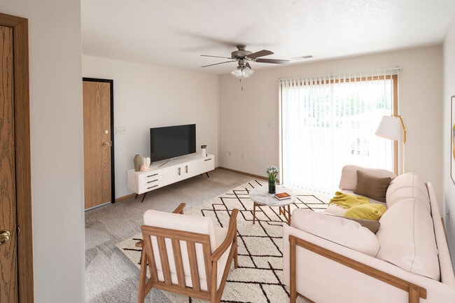 Highland Meadows Apartments in Bellevue, NE Naturally-lit Living Room with Widescreen TV - Highland Meadows