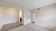 Located at 2730 Lafferty Road in Pasadena, TX, this 2-bedroom, 1-bathroom unit offers a practical and well-organized single-floor layout. The galley-style kitchen is outfitted with white cabinetry, granite-look countertops, a stainless steel sink, and black appliances including a range and refrigerator, all set over wood-look flooring. The living room features neutral carpet, a front entry door, and a window fitted with blinds that allows natural light to filter in. Both bedrooms are carpeted and finished in warm neutral tones. The spacious primary bedroom benefits from dual windows with outdoor views of surrounding greenery and includes a ceiling fan with light fixture and a textured ceiling. The second bedroom also features a window with natural light and outdoor views. The full bathroom is appointed with a white vanity, granite-look countertop, a lighted mirror, wood-look flooring, and a bathtub-shower combination. A dedicated closet provides additional storage. The unit maintains a consistent neutral color palette throughout, creating a cohesive and move-in-ready atmosphere.