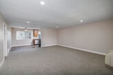 Located at 10233 Mission Gorge Rd in Santee, CA, this single-story, three-bedroom, one-bathroom home offers a practical and comfortable layout. The open living room is a welcoming space featuring neutral carpet, recessed lighting, and a wall-mounted air conditioning unit, creating a bright and functional area for everyday living. It flows seamlessly into the combined dining room and kitchen, where warm wood-toned cabinetry, granite-style countertops, a stainless steel refrigerator, dishwasher, and durable wood-look flooring come together for an efficient and attractive workspace. Natural light enters through windows dressed with vertical blinds throughout the home. Each of the three bedrooms is carpeted and equipped with a ceiling fan, providing comfort year-round. The spacious primary bedroom features a mirrored sliding closet door, adding depth to the room. Impressively, the home includes six closets in total, offering abundant storage across the layout. The full bathroom is clean and well-appointed, featuring a tub-shower combo, granite-style vanity countertop, wood-look flooring, and a privacy window. A connecting hallway ties the bedrooms and bathroom together, completing this efficient and move-in-ready home.