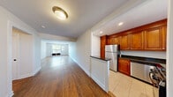 This single-floor residence at Greenwich Close offers a thoughtfully designed layout across three bedrooms and two bathrooms. The open living area is a welcoming focal point, featuring warm hardwood flooring that extends throughout the main living spaces and large windows that invite generous natural light, offering pleasant outdoor views of surrounding greenery.

The kitchen is efficiently designed and well-equipped, showcasing rich cherry wood cabinetry that extends to the ceiling, dark granite countertops, and a full suite of stainless steel appliances including a gas range, refrigerator, and dishwasher. Tile flooring grounds the kitchen, and a window above the sink provides natural light. A peninsula counter separates the kitchen from the main living area, creating a functional transition between spaces.

Each of the three bedrooms features hardwood flooring and windows that bring in natural light. The neutral wall tones throughout provide a clean, versatile backdrop. The two bathrooms are finished in white, with one featuring a tiled tub-shower combination with a white vanity and mirrored medicine cabinet, and the other offering a glass-enclosed shower stall. The overall ambiance is clean, bright, and move-in ready.