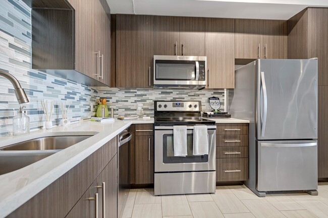 Kitchen and kitchen island within open concept apartment in Boca Raton. - Boca City Walk