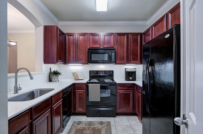 Kitchen with black appliances - Sixteen50 at Lake Ray Hubbard Apartments