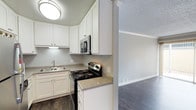 This upgraded 2-bedroom, 1-bathroom single-floor residence offers a well-appointed layout with modern finishes throughout. The kitchen has been thoughtfully renovated, showcasing crisp white shaker-style cabinetry with brushed nickel hardware, granite-look countertops, and a full suite of stainless steel appliances including a refrigerator, electric range, and over-the-range microwave. Dark hardwood-style flooring runs through the kitchen and living areas, adding warmth and a contemporary feel. The living room is spacious and open, featuring crown molding, a ceiling fan, and a sliding glass door that opens directly to a private patio with a fenced outdoor area — ideal for relaxing or entertaining. A dedicated bedroom features plush neutral carpeting, a bright window with natural light, and ample wall space. The bathroom is clean and functional, equipped with a full soaking tub and shower combo with white surround panels and brushed nickel fixtures. Textured ceilings are present throughout, complemented by crisp white trim and a neutral gray color palette that gives the home a cohesive, modern aesthetic. This upgraded unit balances comfort and practicality in a single-level layout.