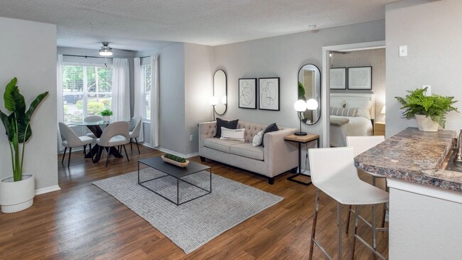 This thoughtfully designed living room flows effortlessly into the solarium, creating a light-filled space perfect for both entertaining and relaxing. - The Oasis at 1800