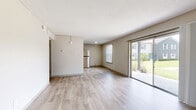 Located at 6900 Concord Drive in Tampa, FL, this single-story 2-bedroom, 1-bathroom unit offers a functional and well-appointed layout. The open living area features light-toned wood-style flooring, neutral wall tones, and a textured ceiling, creating a bright and airy atmosphere. A sliding glass door floods the space with natural light while providing direct access to a private patio with outdoor views.

The kitchen is equipped with stainless steel appliances — including a range, over-the-range microwave, dishwasher, and refrigerator — complemented by granite countertops and crisp white cabinetry. An adjacent dining area with a window and wood-style flooring adds additional functionality.

Both bedrooms feature plush carpet flooring and generous closet space; the primary bedroom includes a mirrored sliding-door closet and a dedicated window for natural light. The shared bathroom offers a granite-topped vanity with an undermount sink and modern fixtures, accessible via the hallway that connects the main living areas.

The unit includes four closets throughout for ample storage. The hallway connecting the rooms is finished with the same light wood-style flooring seen in the common areas, providing a cohesive look throughout the home.