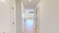 Located at 416 Vine St in Philadelphia's historic Old City neighborhood, this thoughtfully designed studio unit maximizes every inch of its compact single-floor layout. Light hardwood flooring and crisp white walls flow throughout, creating a bright, cohesive aesthetic.

The open-concept kitchen and living area is a standout feature, anchored by a modern galley-style kitchen outfitted with stainless steel GE appliances — including a refrigerator, range, over-the-range microwave, and dishwasher. Two-tone cabinetry pairs white upper cabinets with warm wood-toned lower cabinets and gold hardware, complemented by a white subway tile backsplash and light quartz countertops.

The living area features a large window that draws in generous natural light and offers views of the surrounding greenery. A built-in Murphy bed system with an integrated sofa and wood-paneled ceiling detail provides a versatile, space-efficient sleeping and lounging solution.

The bathroom is finished to a high standard, showcasing floor-to-ceiling vertical white tile in a glass-enclosed walk-in shower, mosaic tile flooring, matte black fixtures, and a backlit mirror. Two closets and a dedicated laundry area round out the practical amenities, making this a fully functional and stylish urban residence.
