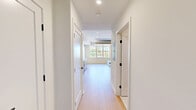 Located at 416 Vine St in Philadelphia's historic Old City neighborhood, this thoughtfully designed studio unit maximizes every inch of its compact single-floor layout. Light hardwood flooring and crisp white walls flow throughout, creating a bright, cohesive aesthetic.

The open-concept kitchen and living area is a standout feature, anchored by a modern galley-style kitchen outfitted with stainless steel GE appliances — including a refrigerator, range, over-the-range microwave, and dishwasher. Two-tone cabinetry pairs white upper cabinets with warm wood-toned lower cabinets and gold hardware, complemented by a white subway tile backsplash and light quartz countertops.

The living area features a large window that draws in generous natural light and offers views of the surrounding greenery. A built-in Murphy bed system with an integrated sofa and wood-paneled ceiling detail provides a versatile, space-efficient sleeping and lounging solution.

The bathroom is finished to a high standard, showcasing floor-to-ceiling vertical white tile in a glass-enclosed walk-in shower, mosaic tile flooring, matte black fixtures, and a backlit mirror. Two closets and a dedicated laundry area round out the practical amenities, making this a fully functional and stylish urban residence.