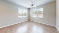 Located at 10191 Main St in Houston, TX, this well-appointed 1-bedroom, 1-bathroom unit offers a thoughtfully designed single-floor layout with a clean, modern aesthetic throughout. Light wood-style flooring flows seamlessly across every room, complementing the neutral color palette that lends the space a bright and airy feel.

The kitchen serves as a standout feature, showcasing white shaker-style cabinetry, granite countertops, a tile backsplash, and a full suite of stainless steel appliances including a refrigerator, range, microwave, and dishwasher. A central island provides additional counter space and casual seating, while recessed lighting illuminates the area. The kitchen opens directly into the combined dining and living area, creating a cohesive and functional open-concept space.

The bedroom is generously proportioned, featuring two large windows that bring in abundant natural light and offer outdoor views, along with a ceiling fan for added comfort. An attached walk-in closet with built-in shelving and hanging rods provides ample storage.

The bathroom is finished with a granite-topped vanity, white cabinetry, and a tub-shower combination accented by classic white subway tile. Additional conveniences include a dedicated laundry area, pantry, entrance foyer, and hallway, rounding out this well-organized and modern Houston residence.