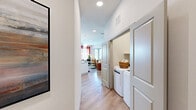 Located at 8157 Ederville Rd in Fort Worth, TX, this single-floor, 2-bedroom, 2-bathroom residence offers a thoughtfully designed layout with modern finishes throughout. The kitchen is a standout feature, boasting shaker-style gray cabinetry, white quartz countertops, a classic subway tile backsplash, and a full suite of stainless steel appliances, including a refrigerator, range, microwave, and dishwasher. Light hardwood flooring and abundant natural light from large windows create a bright, welcoming atmosphere. The open living room flows seamlessly from the kitchen, offering generous space accented by a ceiling fan and large windows dressed with bold red curtains. The primary bedroom features soft blue-gray walls, natural light from oversized windows, and a dedicated closet. The second bedroom mirrors this warmth with sage green walls, large windows, and a ceiling fan. Both bathrooms are finished with marble-style tub surrounds, white quartz vanities, and gray cabinetry. Each bedroom benefits from its own closet, providing ample storage. The consistent hardwood flooring and clean, neutral palette throughout tie the space together for a cohesive, modern living experience.