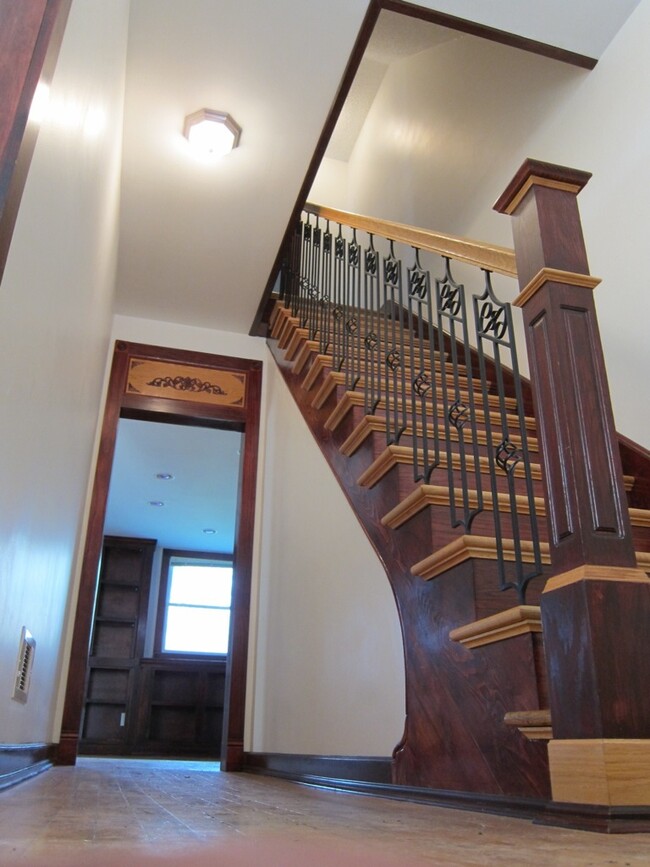 entry, stiarcase, dining room in distance, living room to left. - 575 Jefferson Ave