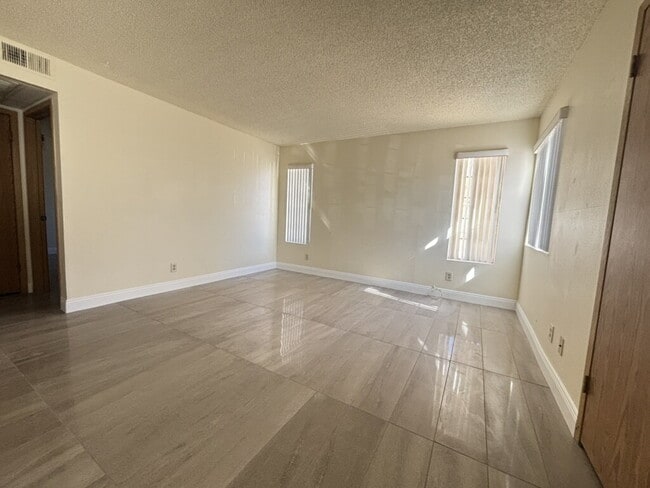 Building Photo - Downstairs 2BR/1BA—recently updated with new flooring, new countertops, and clean, neutral finishes.