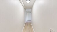 Located at 100 Old York Road in Jenkintown, PA, this two-bedroom, one-bathroom unit offers a well-organized single-floor layout with a clean, neutral aesthetic throughout. Light-toned hardwood flooring flows consistently across the living areas, bedrooms, and hallway, creating a cohesive and airy feel.

The combined kitchen and living room area serves as the heart of the unit. The kitchen is equipped with stainless steel appliances — including a gas range, over-the-range microwave, and refrigerator — complemented by warm honey-toned wood cabinetry and granite-style countertops atop tile flooring. The living room is generously proportioned, featuring recessed lighting, a baseboard heating system, and large windows dressed with vertical blinds that allow ample natural light and offer views of the surrounding greenery.

Both bedrooms continue the hardwood flooring theme and maintain the unit's bright, neutral palette. The primary bedroom is notably spacious, featuring dual windows on adjacent walls that maximize light and outdoor views. A sliding double-door closet provides practical storage. The second bedroom is well-sized with a standard closet.

The bathroom includes a full tub and shower combination with clean white tile surround and a wood-framed vanity. A connecting hallway with flush-mount ceiling lighting ties all rooms together efficiently.