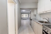 Located at 2166 Boulevard De Maisonneuve Ouest in Montréal, this studio unit offers a clean, modern design across a single floor. The layout flows efficiently from the entrance through a galley-style kitchen and into the open main living area. The kitchen is outfitted with contemporary cabinetry in a warm neutral tone, a stainless steel refrigerator, tile backsplash, and ample counter space along a corridor that naturally guides you into the heart of the unit. Light wood-style flooring runs throughout, lending a bright and cohesive feel to the entire space. The main living area is generously proportioned for a studio, featuring soft grey walls, crisp white baseboards, and a window that allows natural light to fill the room. A built-in closet with bifold doors provides practical storage within the living space. The bathroom is finished in an all-white palette, with large-format floor tiles, a white vanity with under-cabinet storage, a full mirror, and a shower-tub combination, creating a clean and functional retreat. The overall aesthetic is minimal and contemporary, with a neutral colour scheme throughout that maximizes the sense of openness. This unit is well-suited for those seeking a functional and modern living space in a central Montréal location.