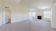 Located at 2427 Partridge Dr in Shelby Township, Michigan, this 2-bedroom, 2-bathroom home offers a comfortable and functional single-floor layout. The open living room is a standout space, featuring vaulted ceilings, plush carpeting, and a tile-surround fireplace flanked by multiple windows and a sliding glass door that floods the room with natural light and views of the surrounding greenery. The kitchen is equipped with warm wood cabinetry, granite-style countertops, and white appliances including a range, microwave, and refrigerator, complemented by light hardwood-style flooring. Both bedrooms are generously sized with soft carpeting and large windows that frame outdoor views. The primary bedroom includes a walk-in closet with wire shelving. The bathrooms feature tile flooring, wood vanities with granite-style countertops, and a glass-enclosed shower. Two closets provide ample storage throughout the home. The attached garage offers additional space with an automatic opener and interior access. Clean, neutral finishes and a bright, airy palette create a welcoming ambiance throughout this well-laid-out Shelby Township home.