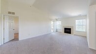 Located at 2427 Partridge Dr in Shelby Township, Michigan, this 2-bedroom, 2-bathroom home offers a comfortable and functional single-floor layout. The open living room is a standout space, featuring vaulted ceilings, plush carpeting, and a tile-surround fireplace flanked by multiple windows and a sliding glass door that floods the room with natural light and views of the surrounding greenery. The kitchen is equipped with warm wood cabinetry, granite-style countertops, and white appliances including a range, microwave, and refrigerator, complemented by light hardwood-style flooring. Both bedrooms are generously sized with soft carpeting and large windows that frame outdoor views. The primary bedroom includes a walk-in closet with wire shelving. The bathrooms feature tile flooring, wood vanities with granite-style countertops, and a glass-enclosed shower. Two closets provide ample storage throughout the home. The attached garage offers additional space with an automatic opener and interior access. Clean, neutral finishes and a bright, airy palette create a welcoming ambiance throughout this well-laid-out Shelby Township home.